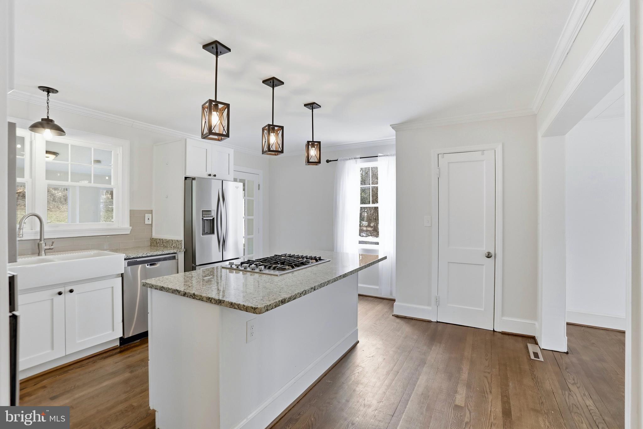 12242 Harpers Ferry Road Purcellville, VA 20132 - Photo 23 of 49 a kitchen that has a lot of cabinets a stove and a wooden floor