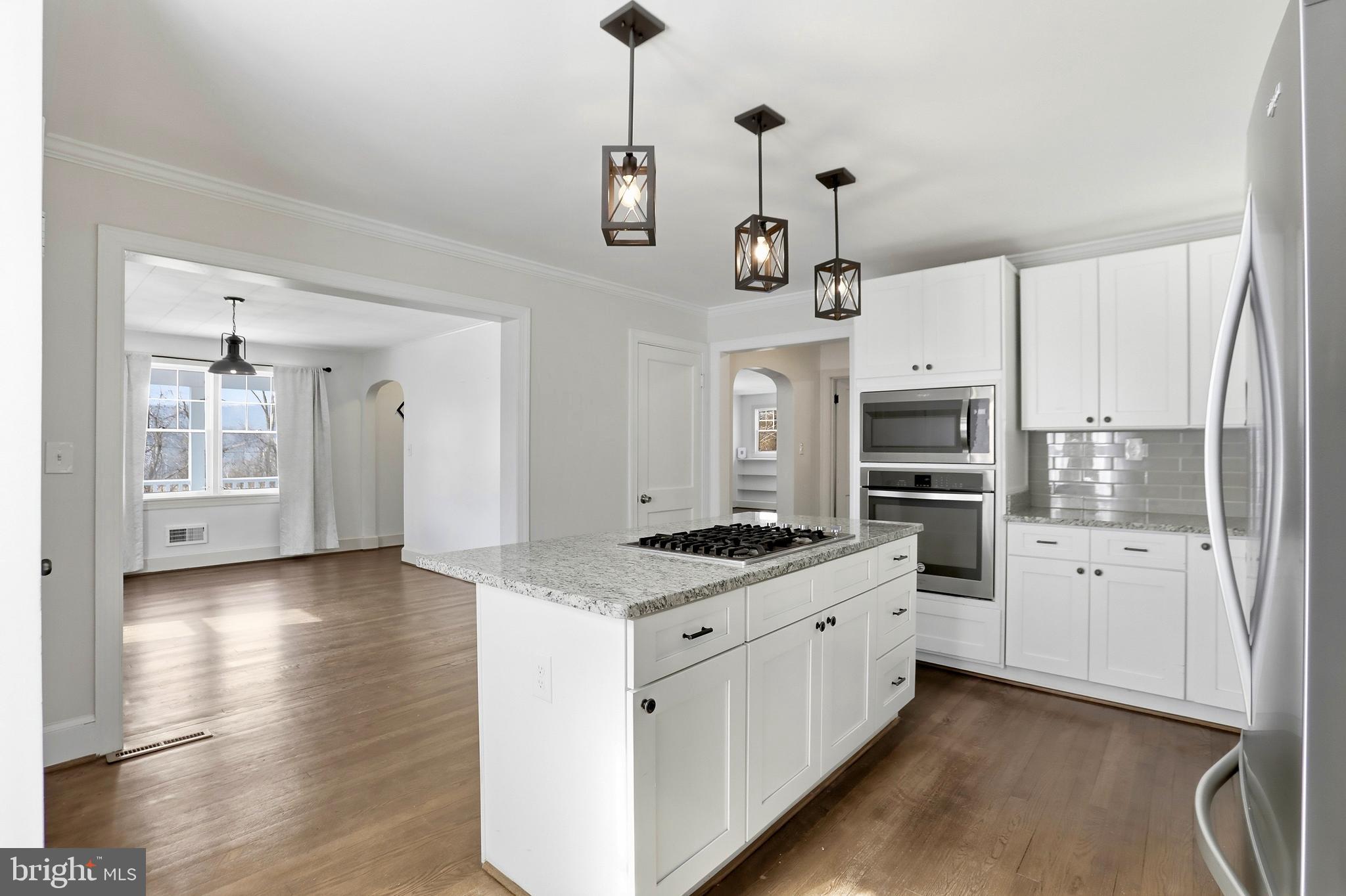 12242 Harpers Ferry Road Purcellville, VA 20132 - Photo 27 of 49 a kitchen with stainless steel appliances kitchen island granite countertop a stove a sink and a refrigerator