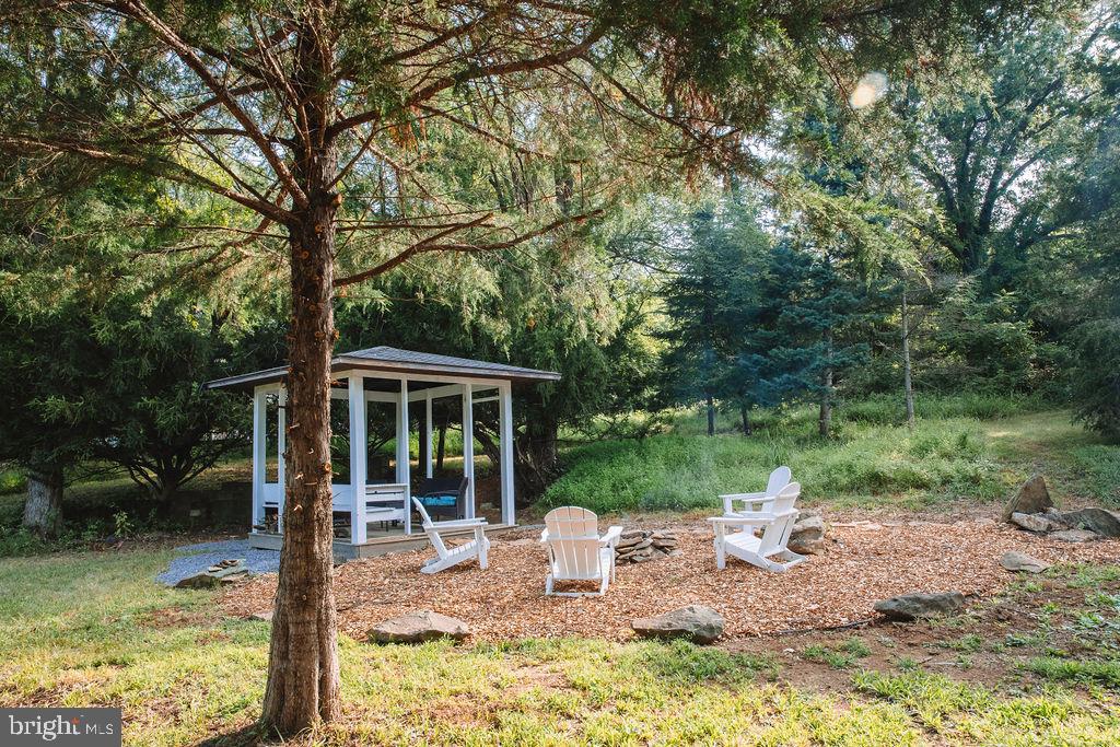 12242 Harpers Ferry Road Purcellville, VA 20132 - Photo 3 of 49 a backyard of a house with yard table and chairs