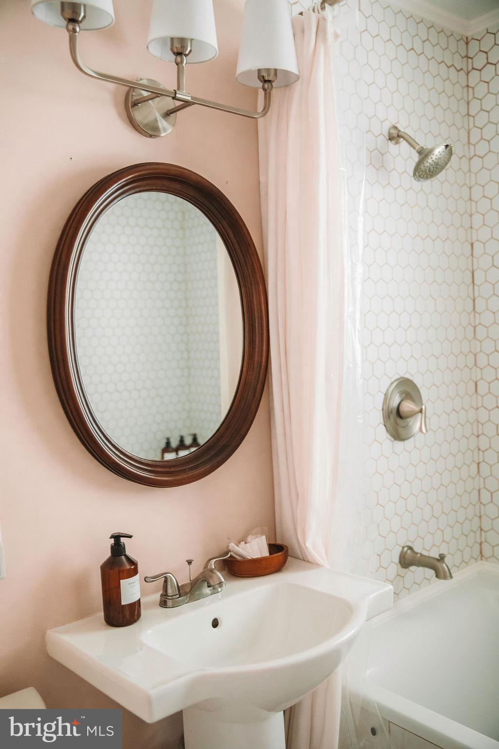 12242 Harpers Ferry Road Purcellville, VA 20132 - Photo 32 of 49 a bathroom with a sink and a mirror