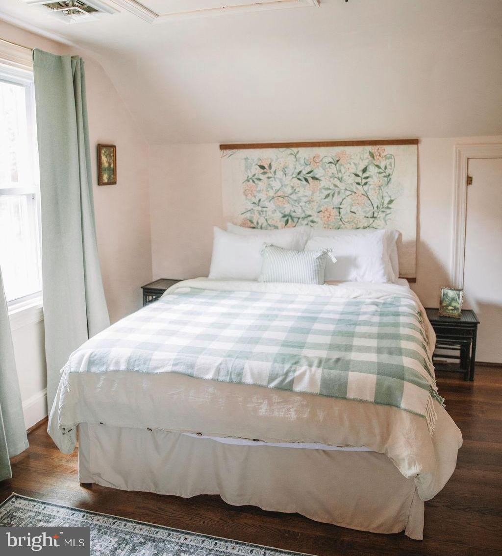 12242 Harpers Ferry Road Purcellville, VA 20132 - Photo 39 of 49 a large bed sitting in a bedroom next to a window
