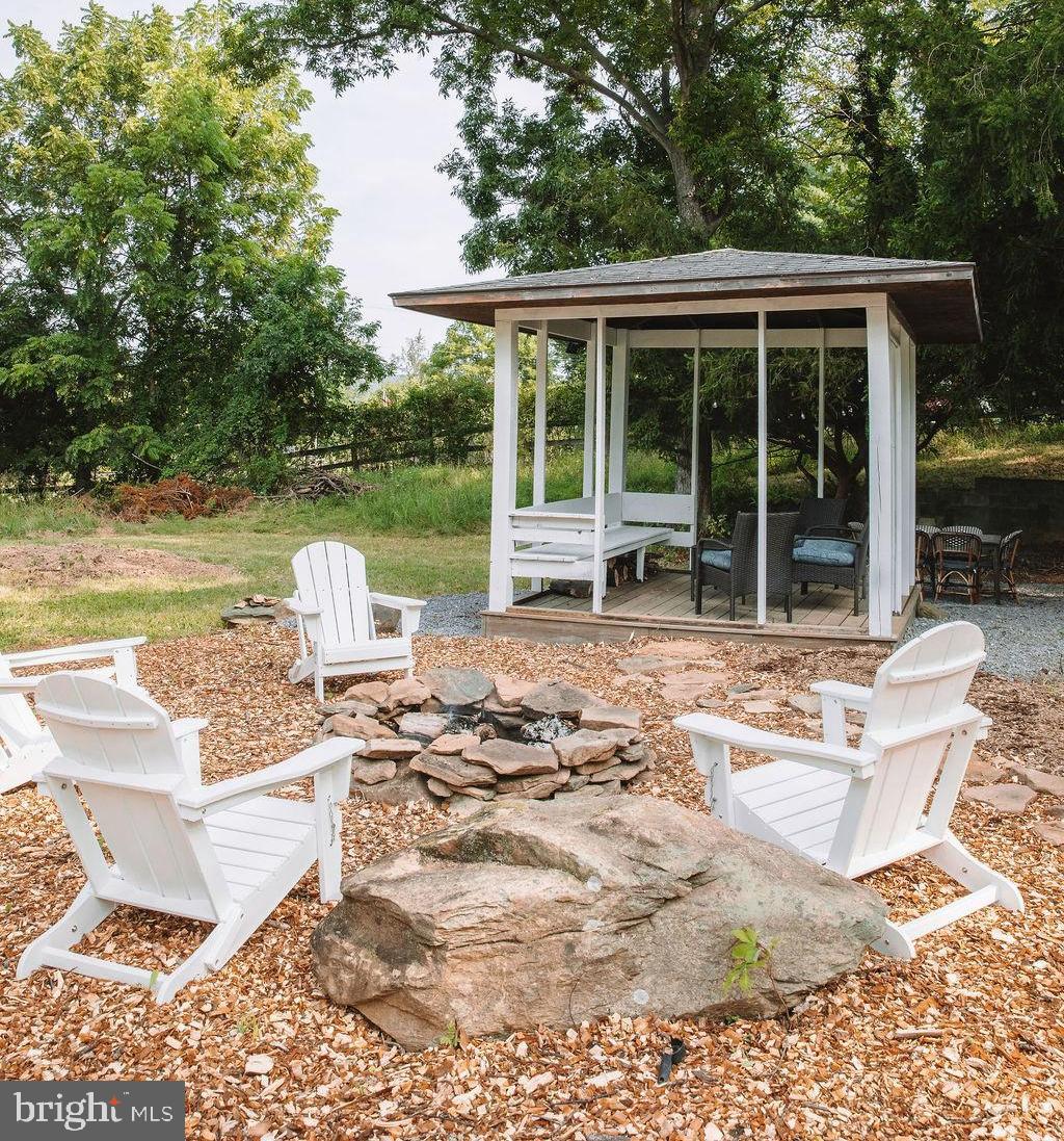 12242 Harpers Ferry Road Purcellville, VA 20132 - Photo 4 of 49 a view of a lounge chair on the deck