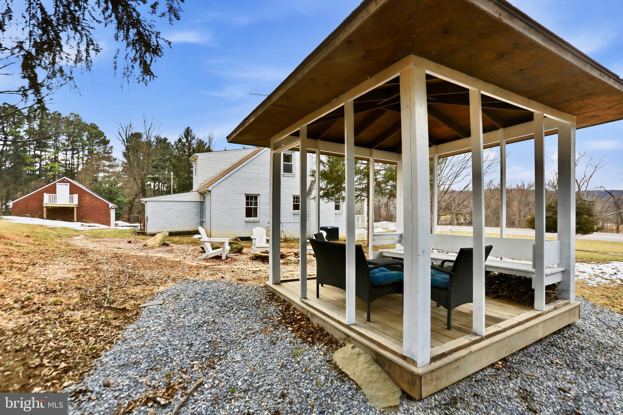 12242 Harpers Ferry Road Purcellville, VA 20132 - Photo 6 of 49 a view of a house with a backyard