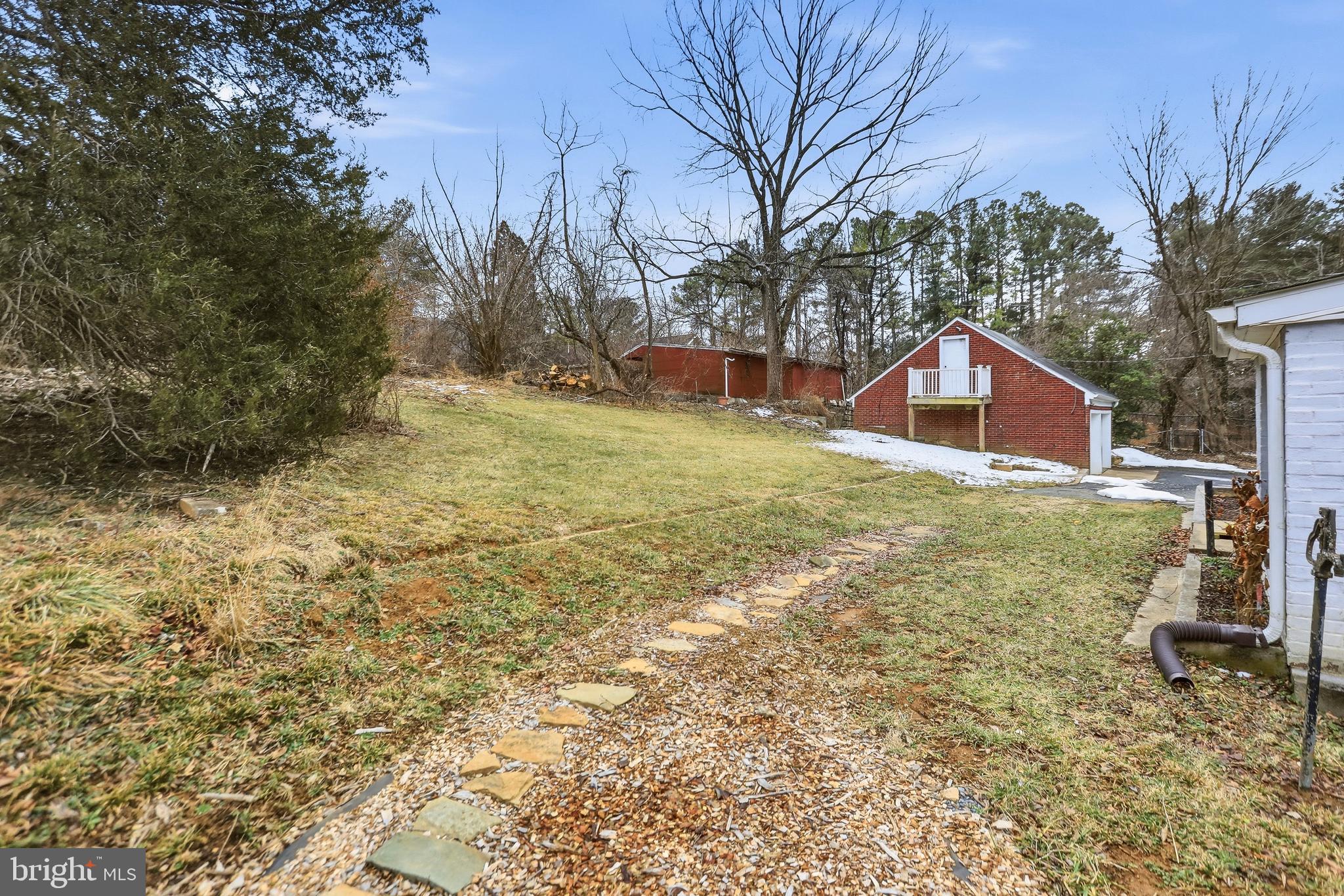 12242 Harpers Ferry Road Purcellville, VA 20132 - Photo 7 of 49 a view of a yard with a house and a tree