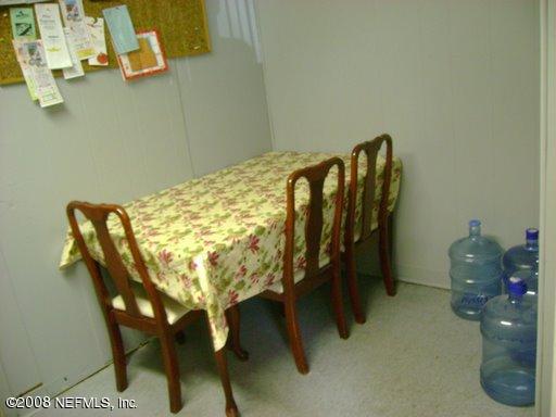 7236 Merrill Road Jacksonville, FL 32277 - Photo 6 of 11 a dining room with furniture and wooden floor