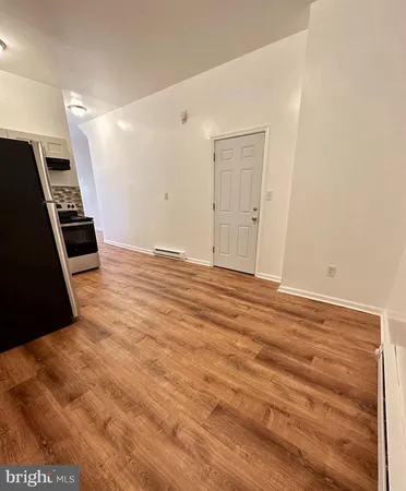 a view of a livingroom with an empty space and a window