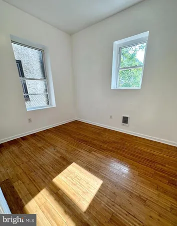 a view of a room with wooden floor and window