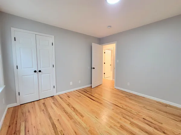a view of an empty room and wooden floor