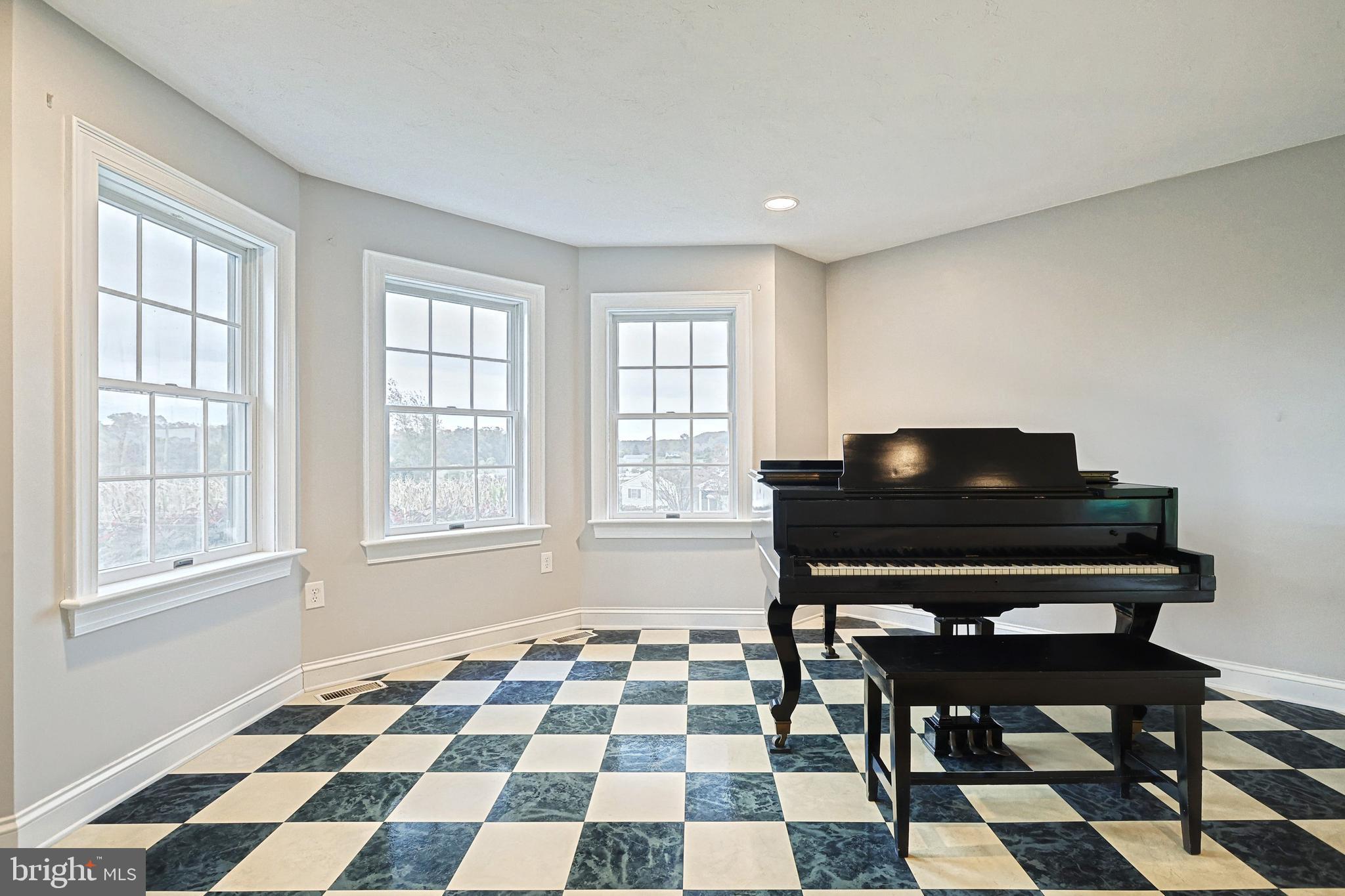 302 Pinetown Road Hanover, PA 17331 - Photo 17 of 55 a living room with a black white checkered floor with a gaming machine and dining chair