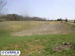 10011 Tribble Road Beaverdam, VA 23015 - Photo 4 of 8 a view of a lake with houses in the back