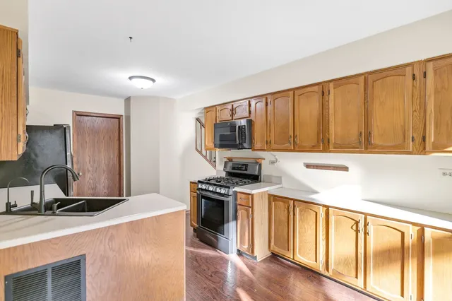 a kitchen that has a sink and a stove top oven