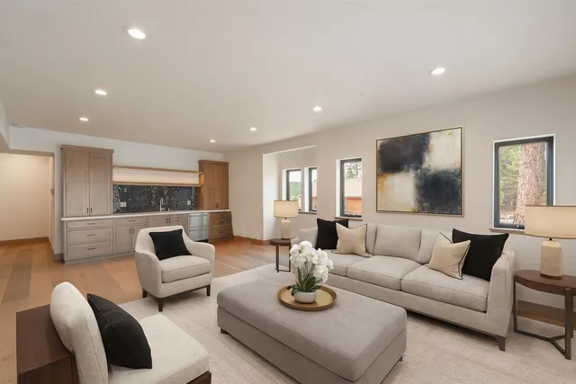 a living room with furniture and view of kitchen