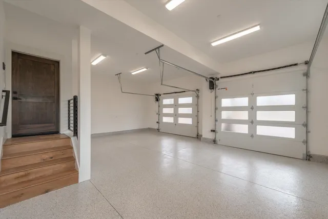 an empty room with windows and pillars in it