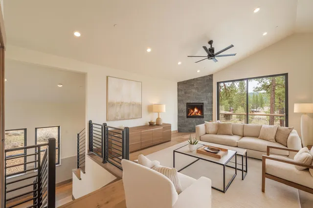 a living room with furniture fireplace and a large window