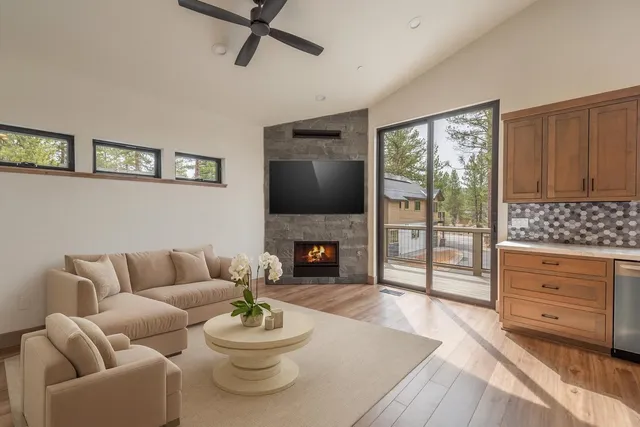 a living room with furniture a fireplace and a flat screen tv