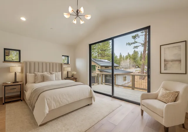 a bedroom with a large bed couch and window