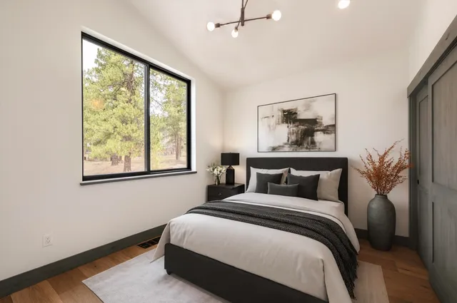 a bedroom with a large bed and a window