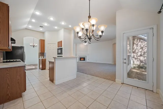 a view of a kitchen with granite countertop cabinets and stainless steel appliances