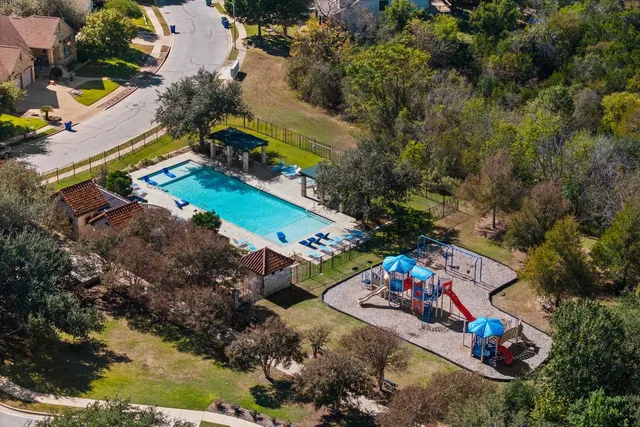 an aerial view of a house with a yard basket ball court and outdoor seating