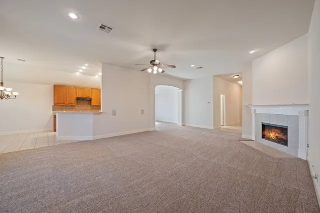 a view of an empty room with a fireplace