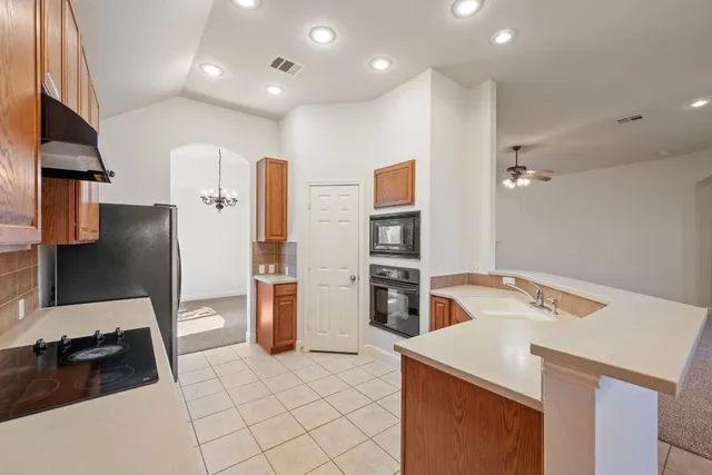 a kitchen that has a sink and a stove in it