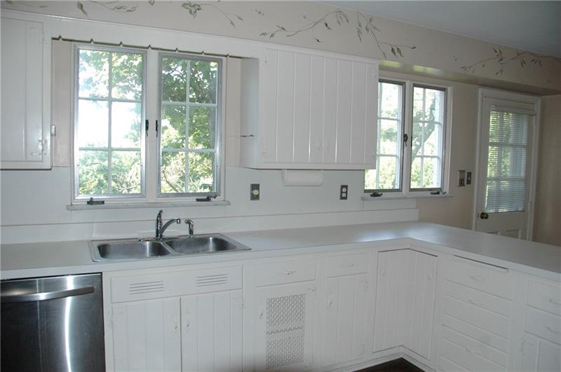 2 Farmhill Road Sewickley, PA 15143 - Photo 11 of 25 Views and access to backyard from neutral white kitchen.