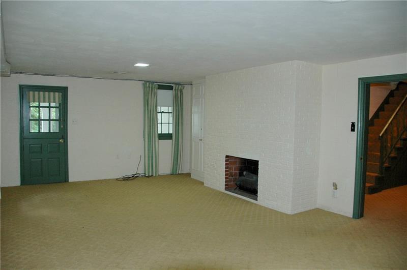 2 Farmhill Road Sewickley, PA 15143 - Photo 21 of 25 Lower level Game Room has gas fireplace and door to back yard and covered terrace.