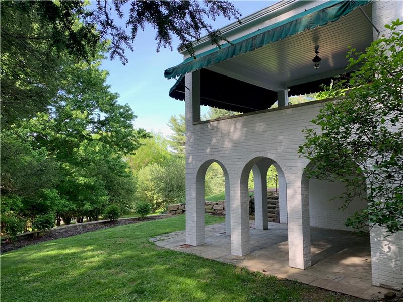 2 Farmhill Road Sewickley, PA 15143 - Photo 23 of 25 Unique arched openings to covered porch on lower level off of Game Room. Above is porch with awnings ideal for enjoying an evening overlooking private yard.