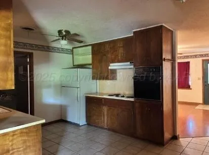 a kitchen with stainless steel appliances a refrigerator and a stove