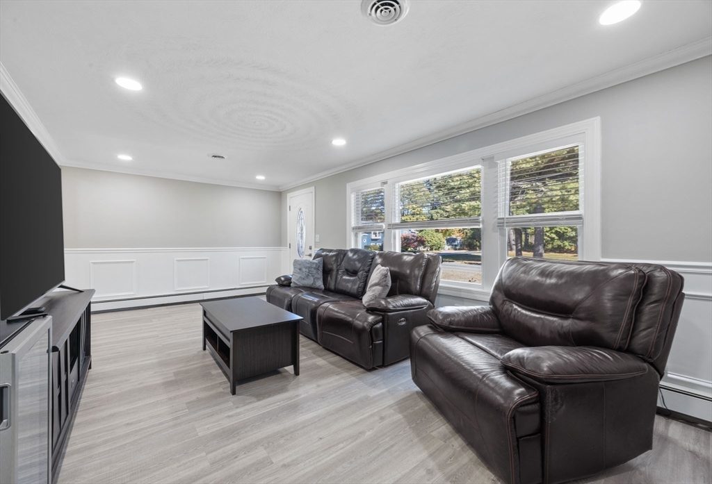124 Lake Street Bellingham, MA 02019 - Photo 12 of 39 a living room with furniture and a flat screen tv