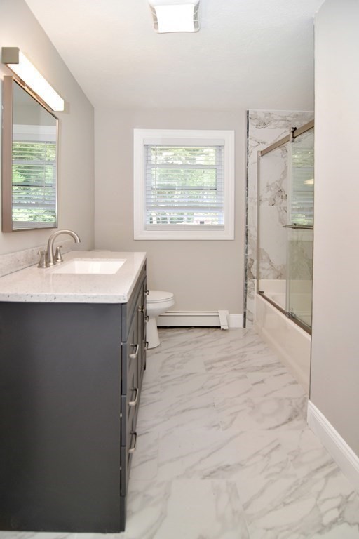 124 Lake Street Bellingham, MA 02019 - Photo 14 of 39 a bathroom with a sink and a mirror