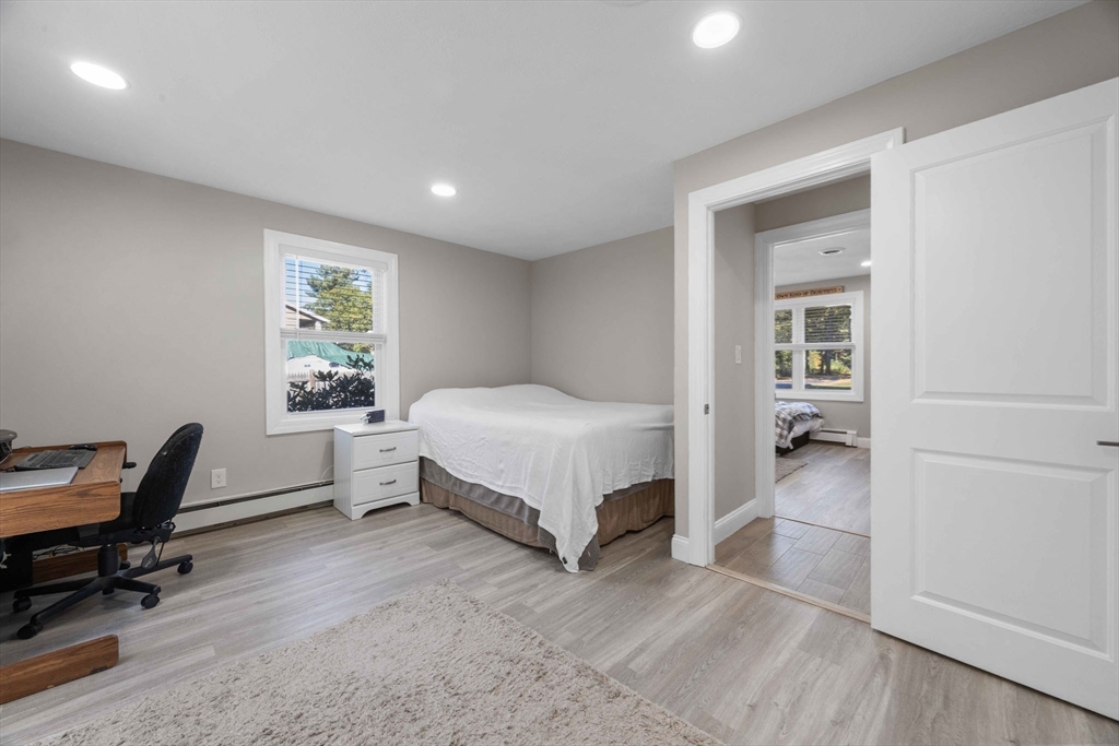 124 Lake Street Bellingham, MA 02019 - Photo 17 of 39 a bedroom with a bed and a chair