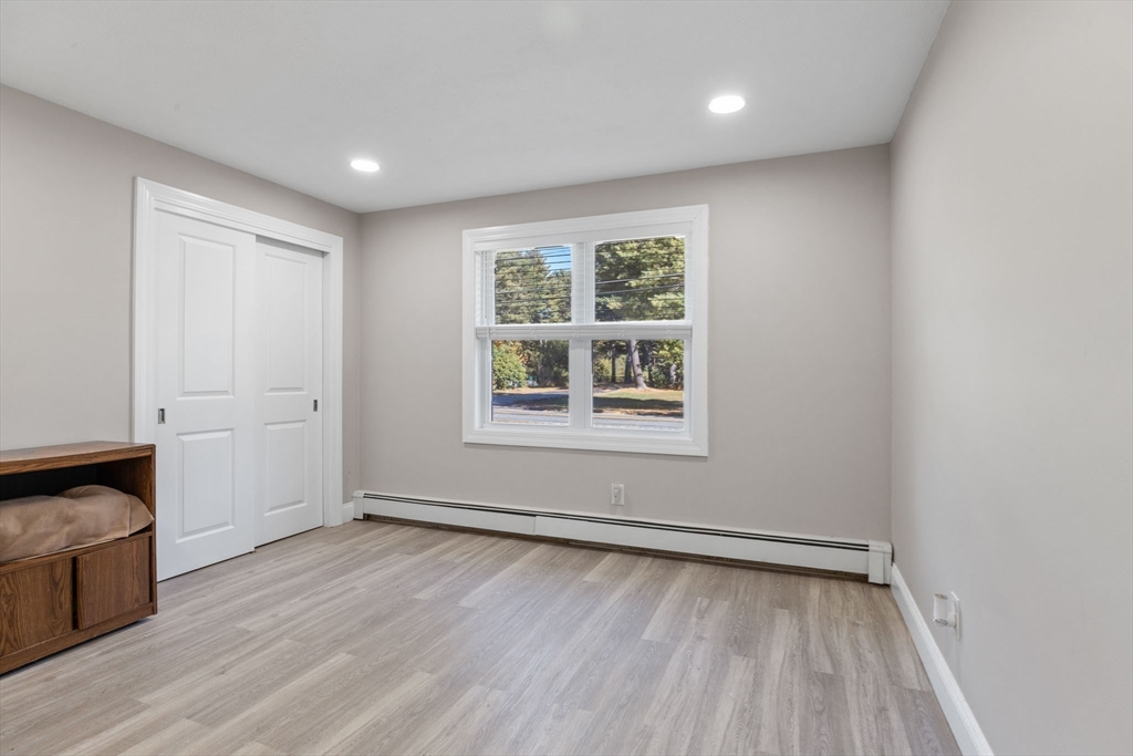 124 Lake Street Bellingham, MA 02019 - Photo 19 of 39 an empty room with wooden floor and windows