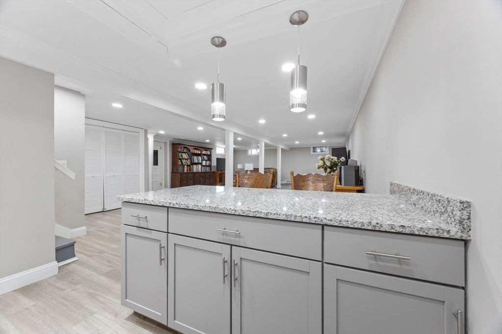 124 Lake Street Bellingham, MA 02019 - Photo 23 of 39 a kitchen with granite countertop white cabinets and a sink