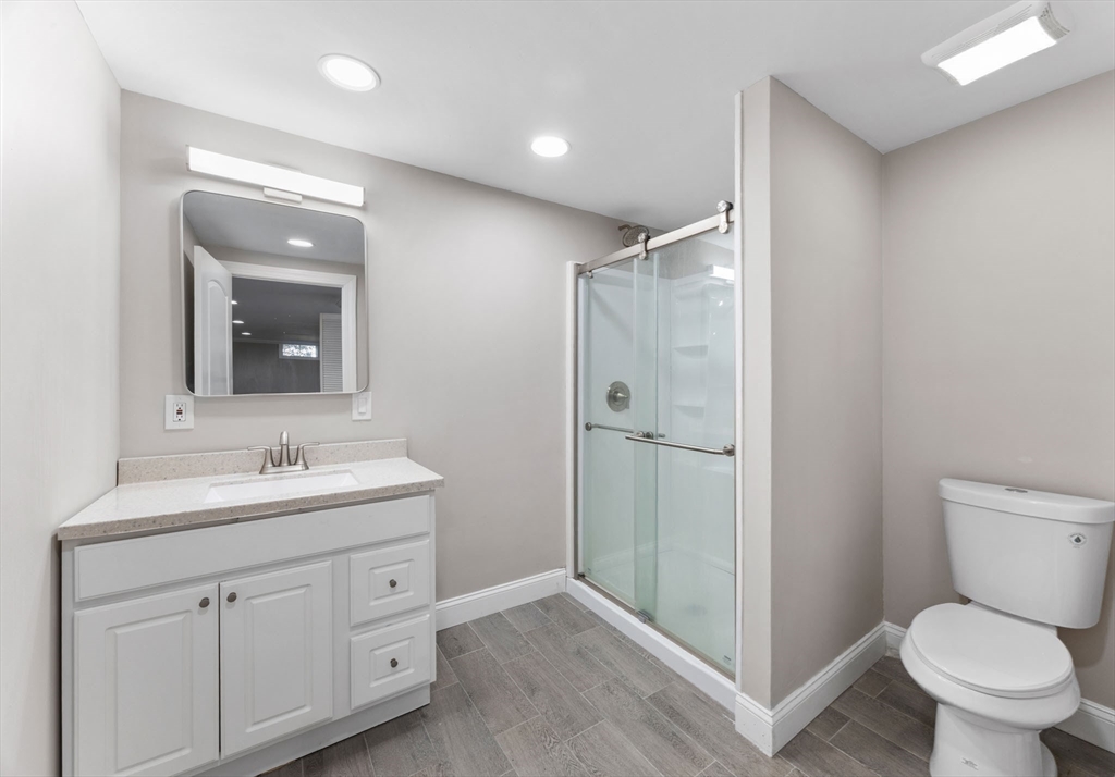 124 Lake Street Bellingham, MA 02019 - Photo 24 of 39 a bathroom with a toilet sink and mirror