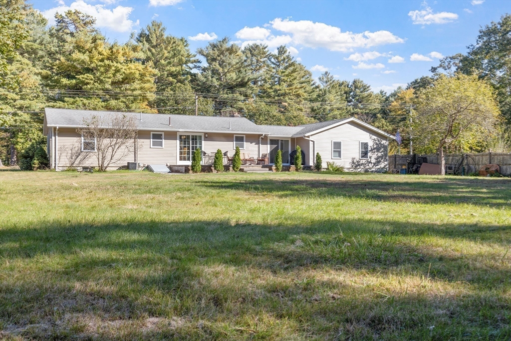 124 Lake Street Bellingham, MA 02019 - Photo 33 of 39 a front view of a house with a garden
