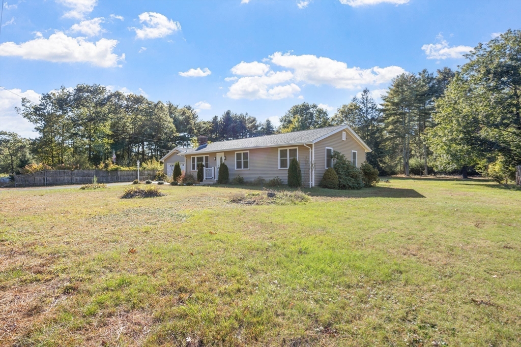 124 Lake Street Bellingham, MA 02019 - Photo 35 of 39 a house view with swimming pool and trees in the background