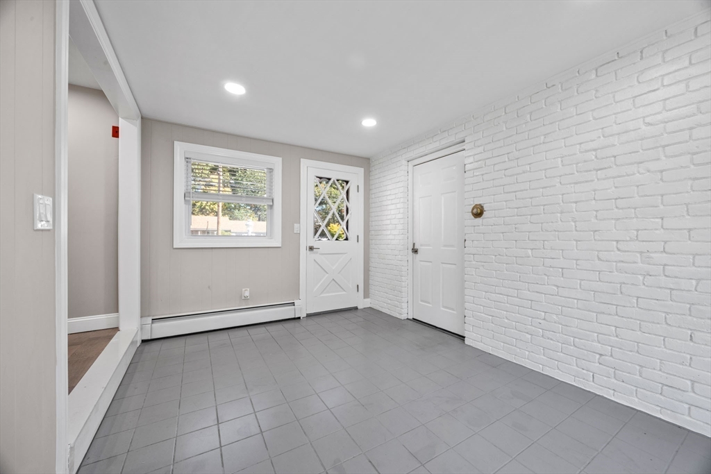 124 Lake Street Bellingham, MA 02019 - Photo 4 of 39 a view of an empty room with a window