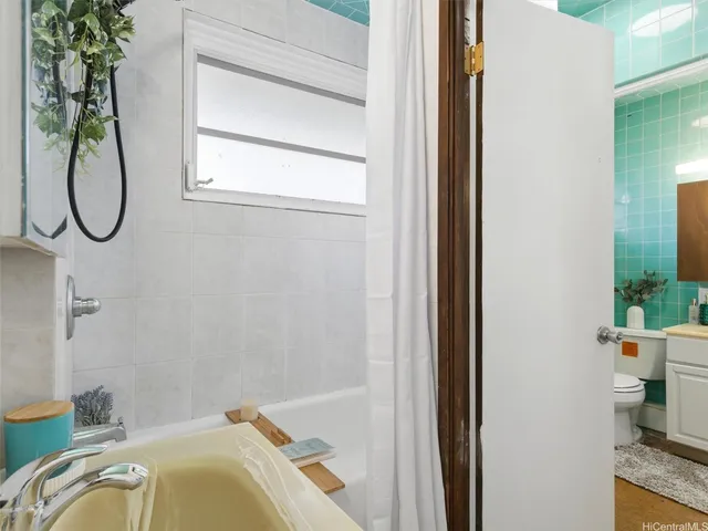 a bathroom with a tub and a window