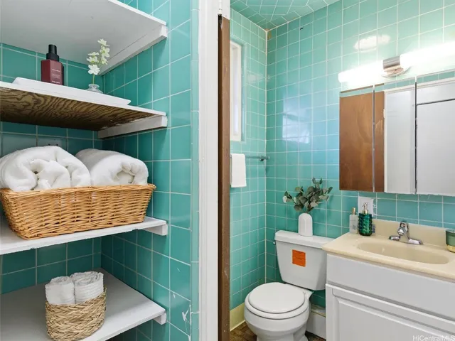 a bathroom with a toilet a sink and mirror