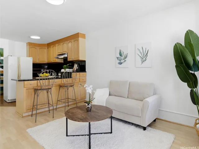 a living room with furniture and kitchen view