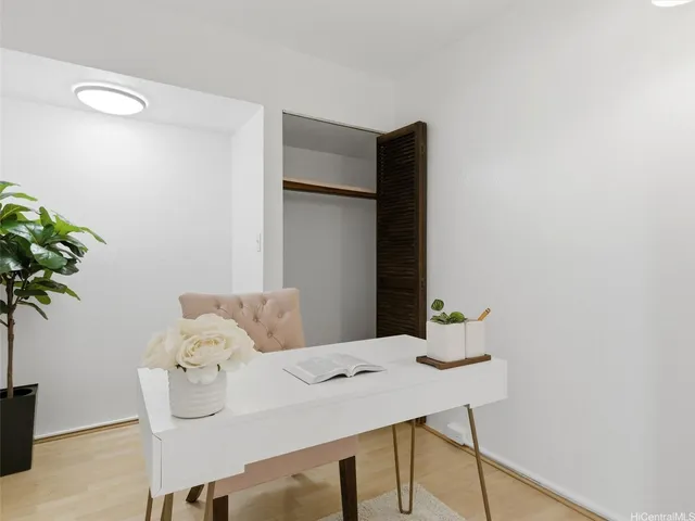 a living room with furniture and a potted plant