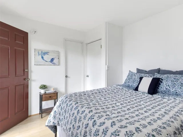 a bedroom with a large bed and a dresser