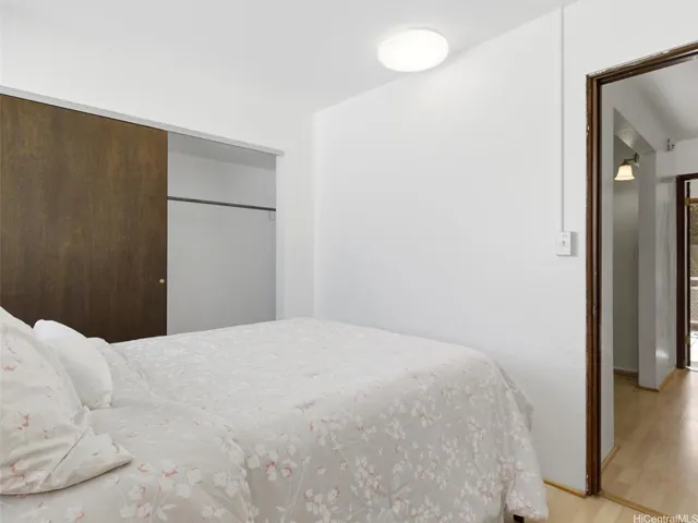 a bedroom with a bed and a mirror