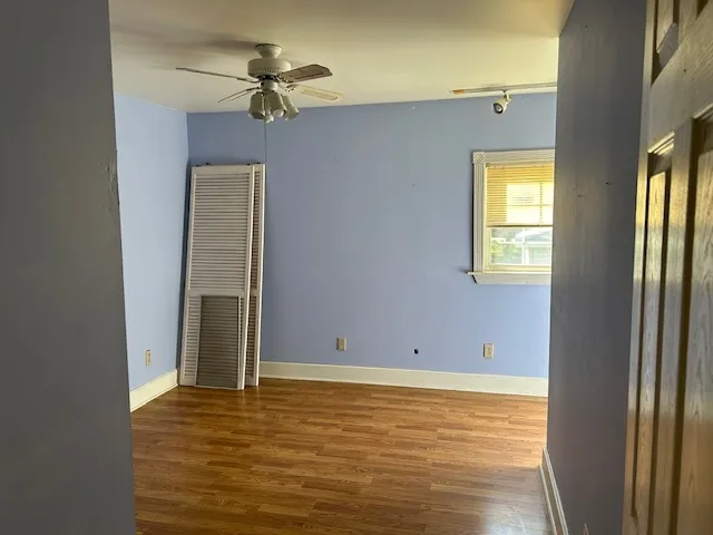 a view of a room with a ceiling fan and a window