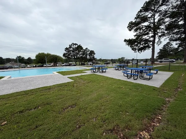 a view of a swimming pool with a table and chairs