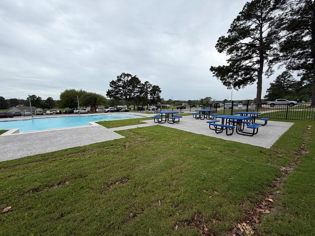 86 Whippoorwill Lane Trinity, TX 75862 - Photo 13 of 47 a view of a swimming pool with a table and chairs
