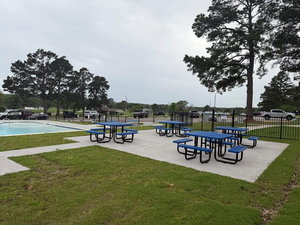 86 Whippoorwill Lane Trinity, TX 75862 - Photo 19 of 47 a view of a swimming pool with lawn chairs and a fire pit
