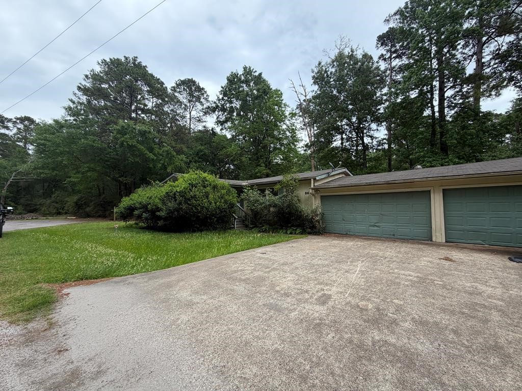 86 Whippoorwill Lane Trinity, TX 75862 - Photo 2 of 47 a backyard of a house with lots of green space