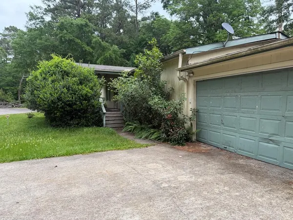 a backyard of a house with lots of green space and plants